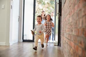 Family entering sunny home