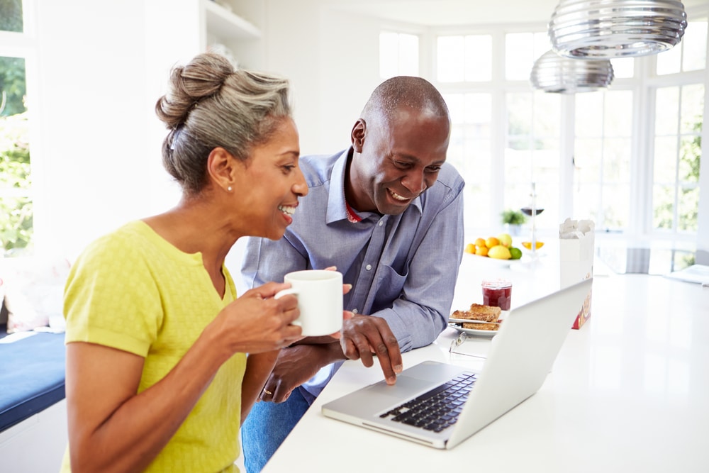 Homeowners looking at laptop computer